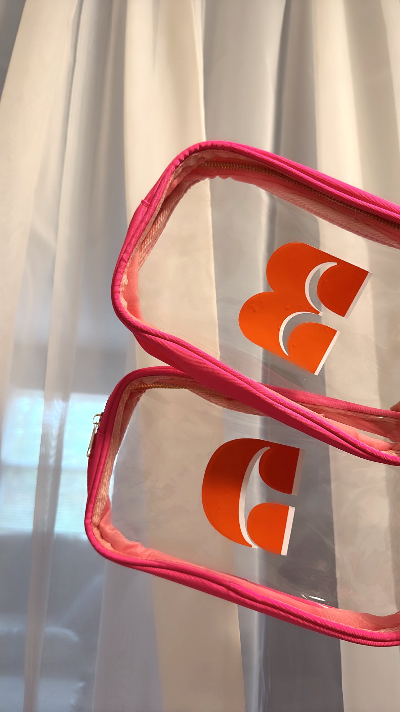 Orange over White Sticker in NOLA font on Hot Pink Medium Pouch